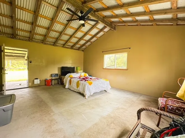 a bed room with a bed and a chair