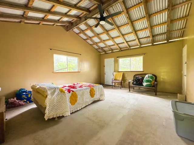 a spacious bedroom with a bed and a chandelier