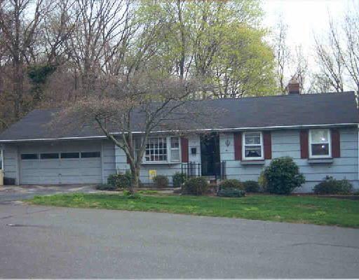 30 Mountain View Road Ansonia, CT 06401 - Photo 1 of 1 a front view of a house with a garden and trees