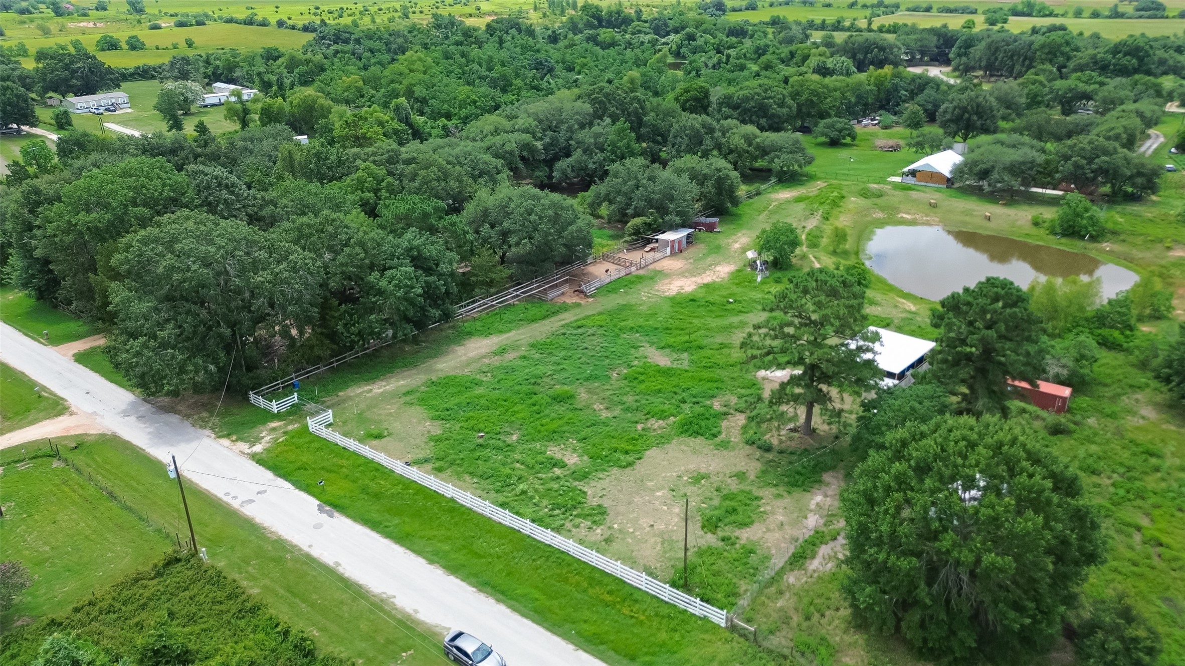 35535 Windmill Road Hempstead, TX 77445 - Photo 1 of 41 Expansive rural property with lush greenery, a pond, and fenced areas, ideal for outdoor activities. Offers privacy and tranquility with easy road access. Perfect for those seeking a serene country lifestyle.