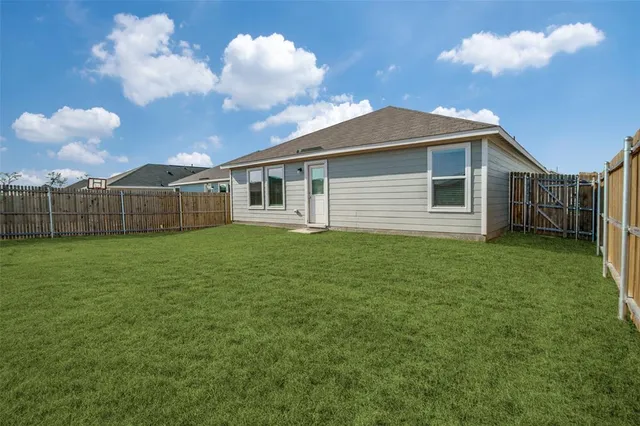a view of a house with a backyard