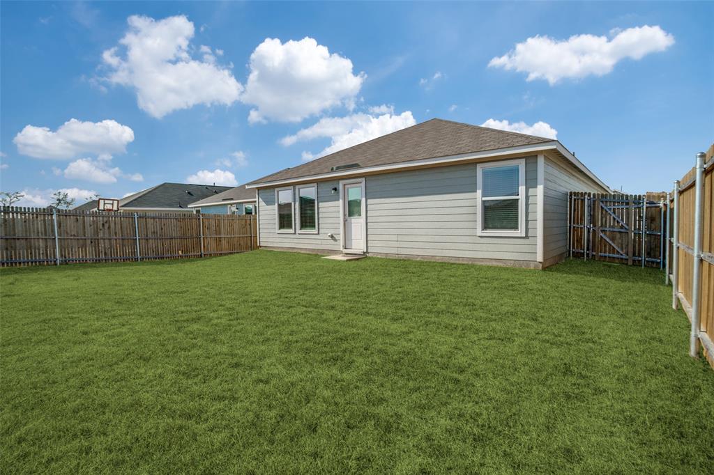 1201 Catclaw Road Princeton, TX 75407 - Photo 17 of 20 a view of a house with a backyard