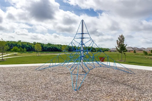 a view of a park with swings and slides