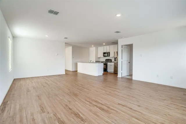 a view of a kitchen with a sink and a refrigerator