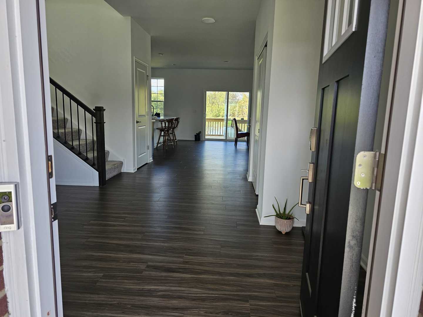 81 Sweetflag Circle Elgin, IL 60124 - Photo 2 of 9 a view of a hallway view with wooden floor and staircase