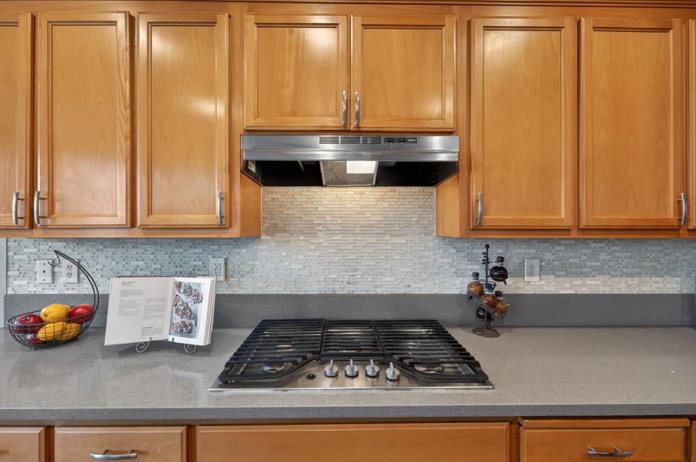 3045 Delta Tule Way Sacramento, CA 95834 - Photo 16 of 65 a kitchen with granite countertop cabinets and white appliances