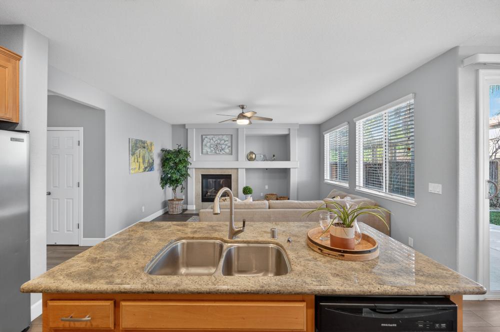 3045 Delta Tule Way Sacramento, CA 95834 - Photo 17 of 65 a kitchen with kitchen island granite countertop a sink and a window