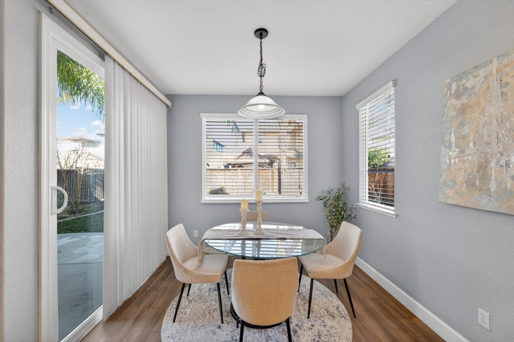 3045 Delta Tule Way Sacramento, CA 95834 - Photo 19 of 65 a dining room with furniture a chandelier and wooden floor