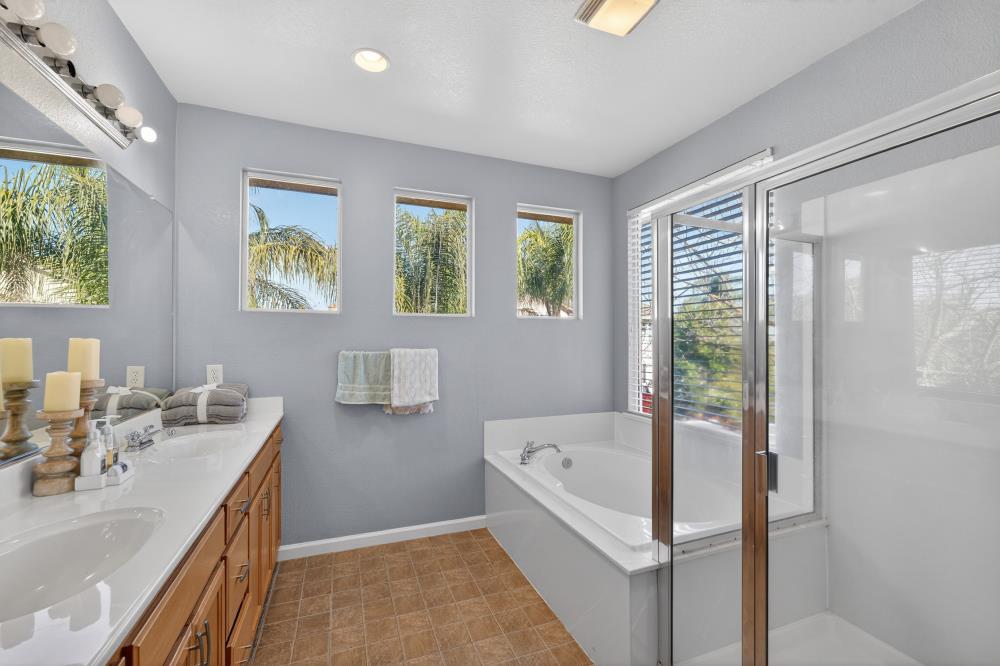 3045 Delta Tule Way Sacramento, CA 95834 - Photo 30 of 65 a bathroom with a tub sink and mirror