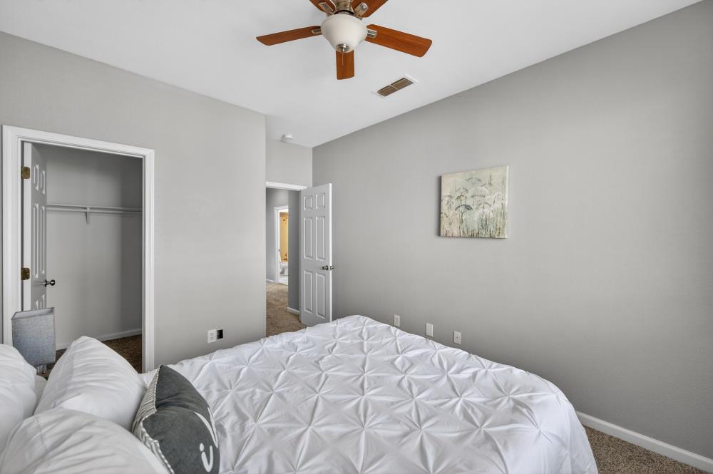 3045 Delta Tule Way Sacramento, CA 95834 - Photo 44 of 65 a bedroom with a bed and a chandelier