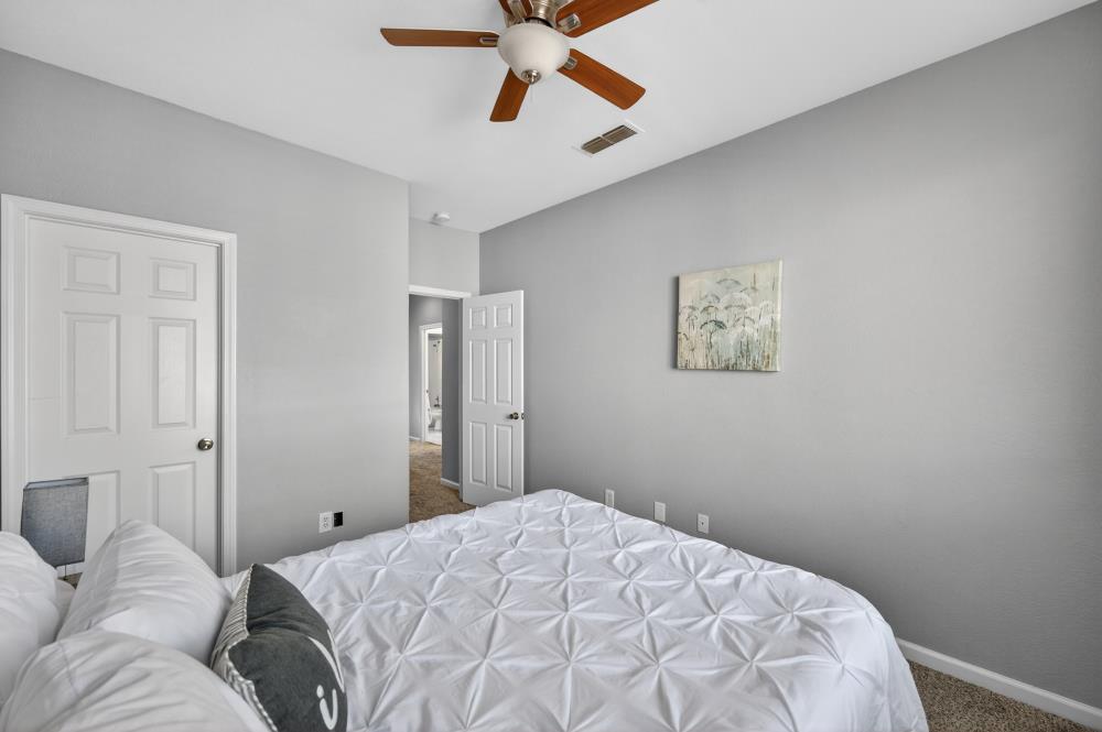 3045 Delta Tule Way Sacramento, CA 95834 - Photo 46 of 65 a bedroom with a bed and a chandelier