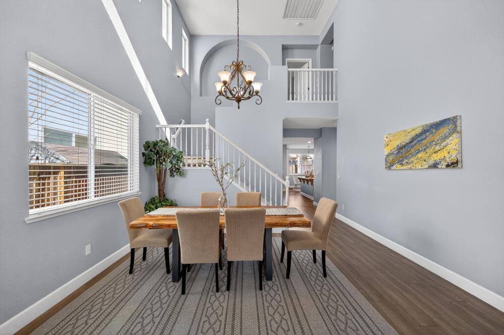 3045 Delta Tule Way Sacramento, CA 95834 - Photo 7 of 65 a view of a dining room with furniture wooden floor and chandelier