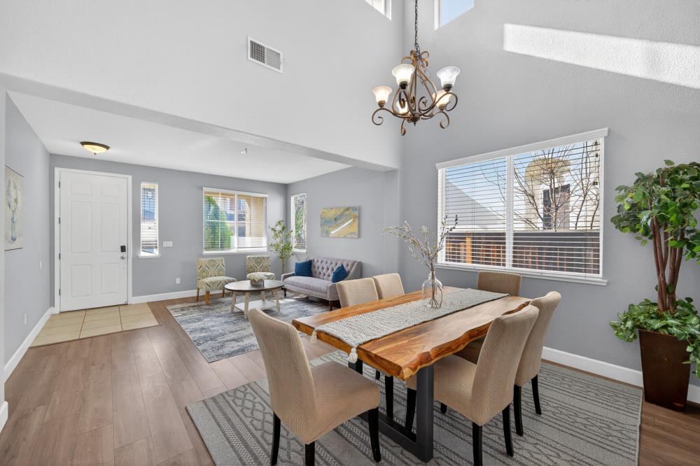 3045 Delta Tule Way Sacramento, CA 95834 - Photo 8 of 65 a living room with furniture a chandelier and a window