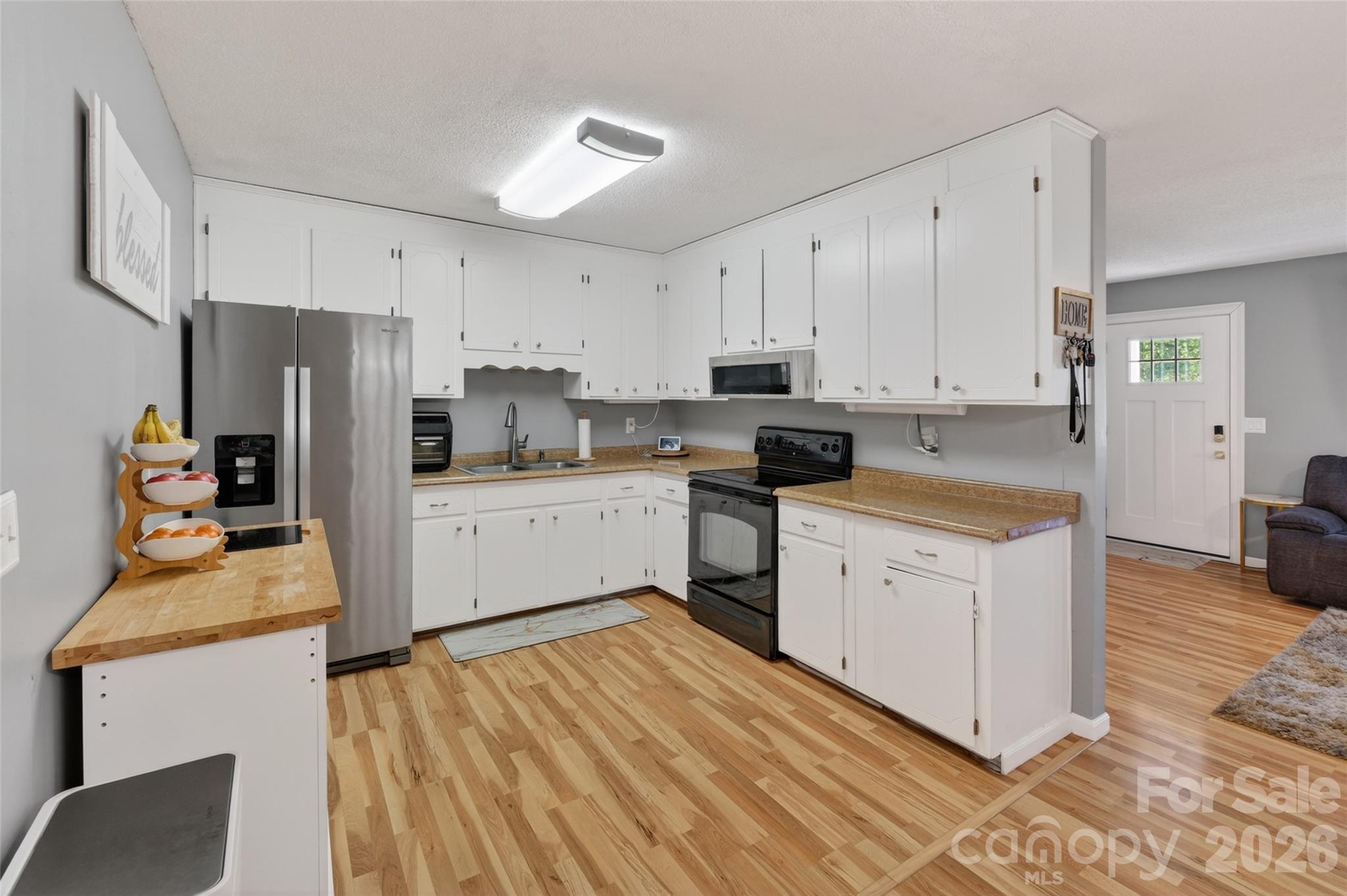 1704 Williams Circle Lancaster, SC 29720 - Photo 7 of 19 a kitchen with white cabinets and stainless steel appliances