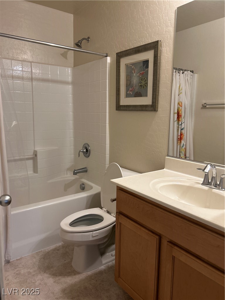 8977 Melridge Road Las Vegas, NV 89148 - Photo 31 of 35 Guest Full bath featuring vanity, a textured wall, shower / bath combo with shower curtain, and toilet