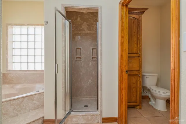 a bathroom with a granite countertop toilet a sink and shower