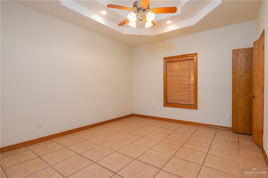 738 County Road 137 Alice, TX 78332 - Photo 14 of 33 an empty room with a chandelier fan and windows