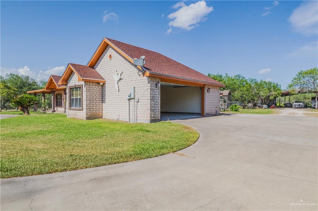 738 County Road 137 Alice, TX 78332 - Photo 23 of 33 a front view of house with yard and trees in the background