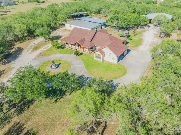 a view of a dirt road and a building