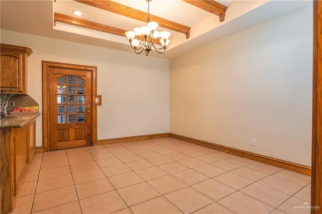 a view of an empty room with a chandelier