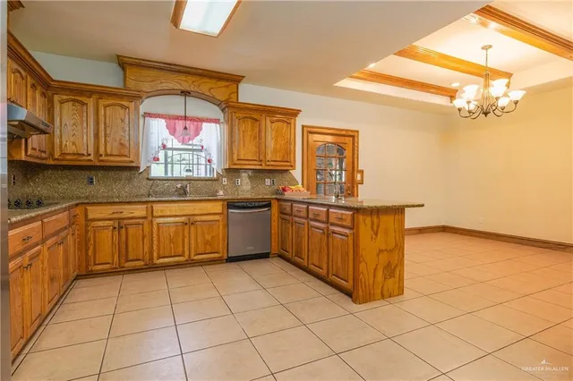 a kitchen with stainless steel appliances a sink window and cabinets