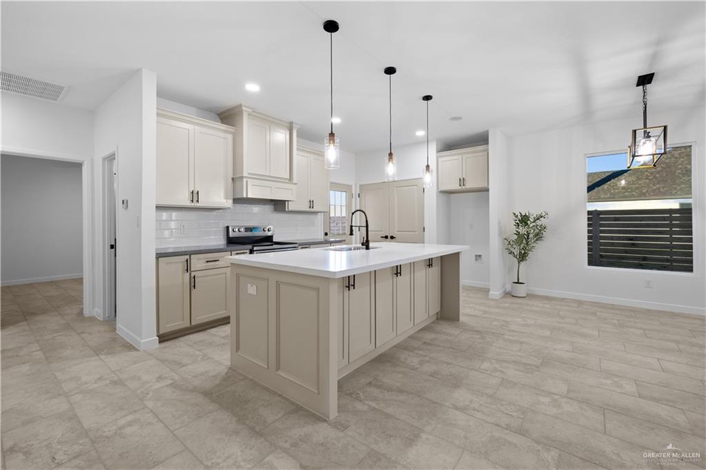2713 East Comal Road Edinburg, TX 78542 - Photo 11 of 29 a kitchen with white cabinets and white appliances