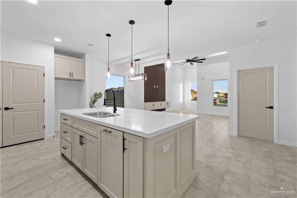 2713 East Comal Road Edinburg, TX 78542 - Photo 29 of 29 a kitchen with a sink and refrigerator