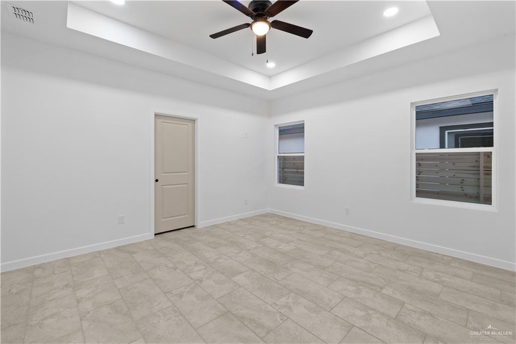 2713 East Comal Road Edinburg, TX 78542 - Photo 13 of 29 a view of an empty room with window and ceiling fan
