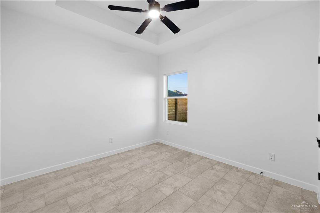 2713 East Comal Road Edinburg, TX 78542 - Photo 19 of 29 an empty room with a ceiling fan and window