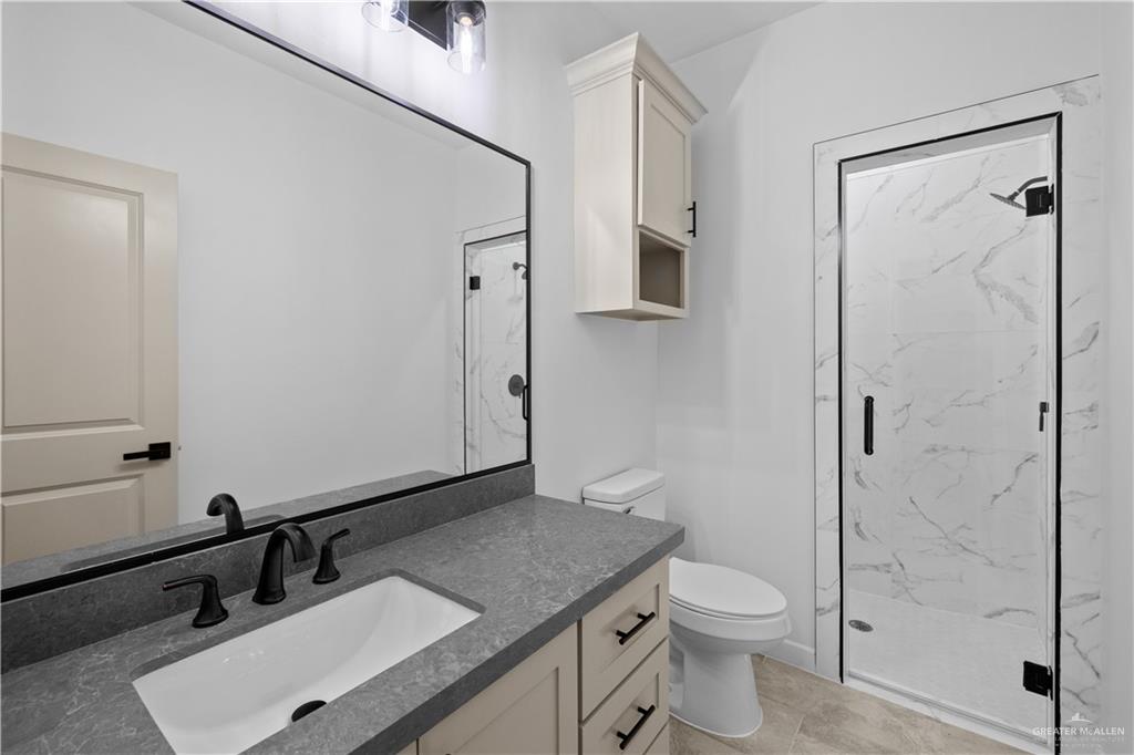 2713 East Comal Road Edinburg, TX 78542 - Photo 21 of 29 a bathroom with a sink toilet and shower