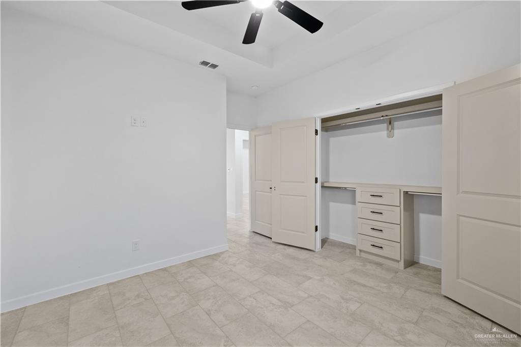2713 East Comal Road Edinburg, TX 78542 - Photo 23 of 29 an empty room with closet and a ceiling fan