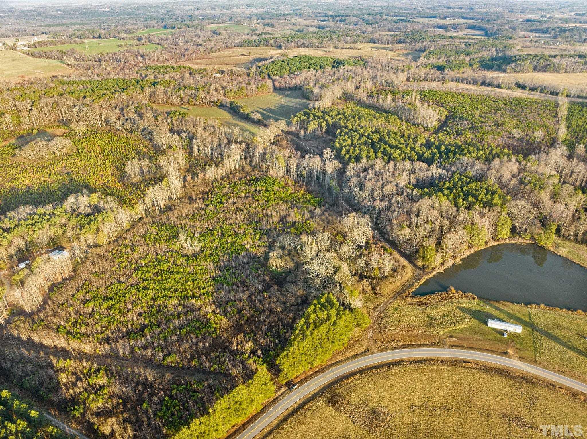 2 B Lettuce Hall Rd Spring Spring Hope, NC 27882 - Photo 3 of 3 a blue swimming pool is in the middle of a lake
