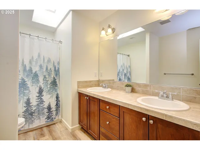 a bathroom with a double vanity sink mirror and double