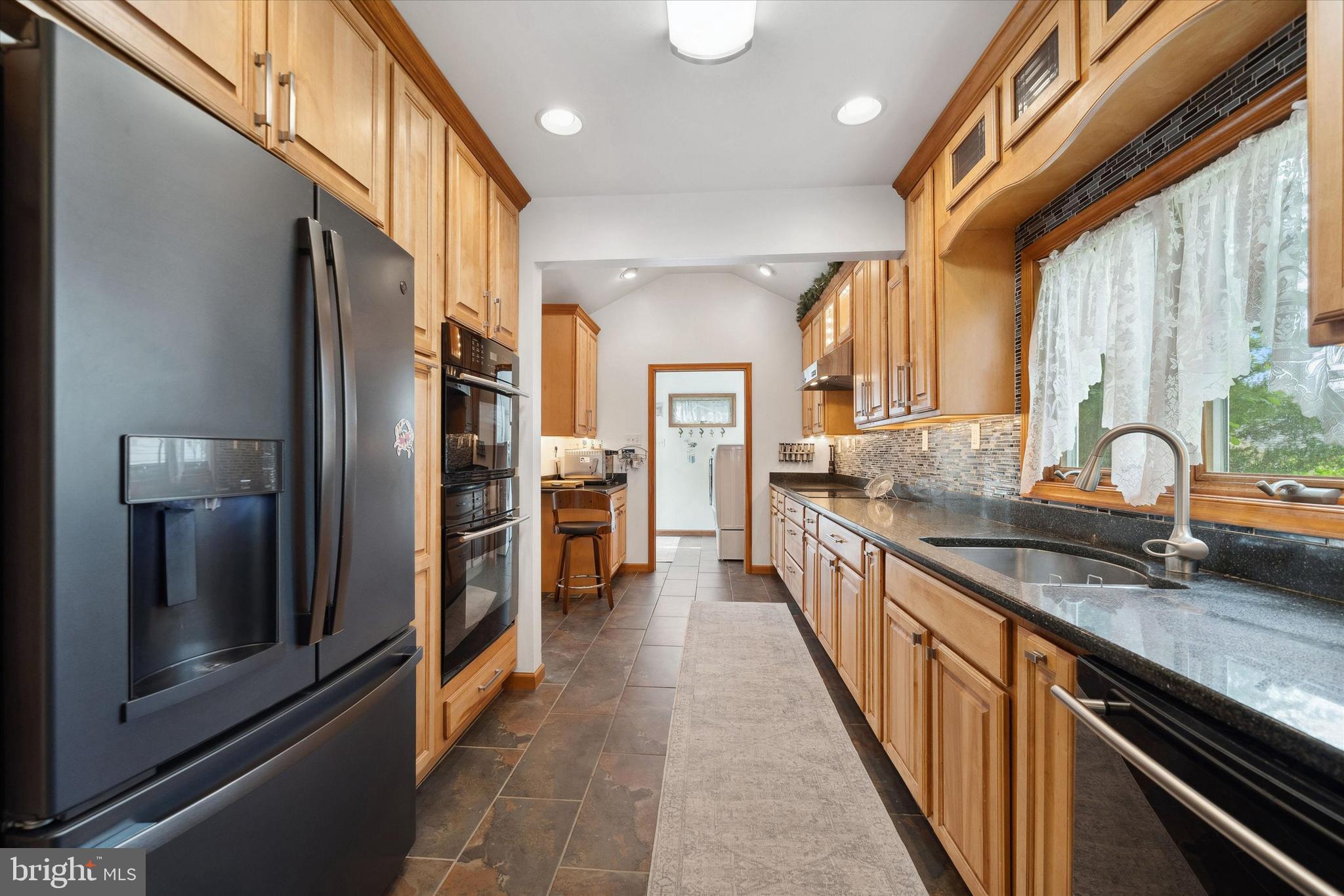 48 Bluff Road Earleville, MD 21919 - Photo 25 of 58 a kitchen with stainless steel appliances granite countertop a sink a stove and a refrigerator