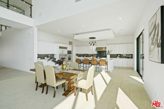 a living room with lots of furniture and kitchen view