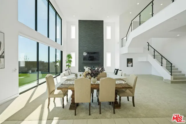 a kitchen with stainless steel appliances a table and chairs in it
