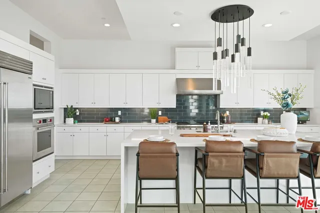 a kitchen with a dining table chairs and white appliances