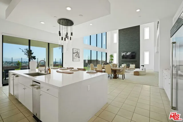 a kitchen with stainless steel appliances a refrigerator sink and cabinets