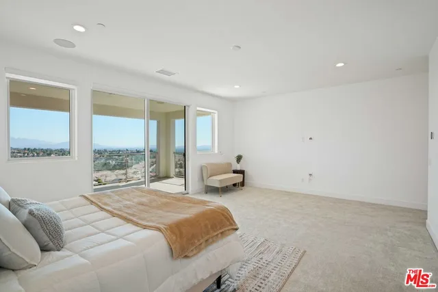 a large white kitchen with a sink