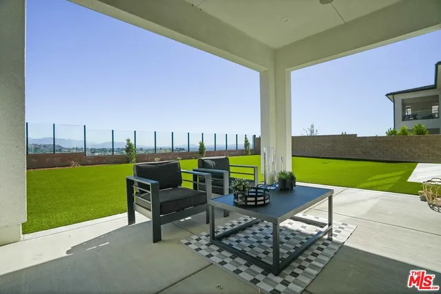 a front view of a house with a garden and yard