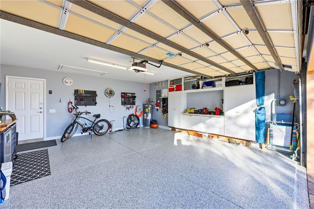 7527 Novara Court Naples, FL 34114 - Photo 30 of 50 Custom Epoxy floor,built in wall unit, updated hot water heater, Generator ready,