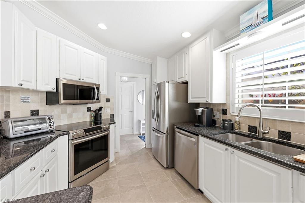 7527 Novara Court Naples, FL 34114 - Photo 7 of 50 Updated Kitchen with stainless steel appliances.