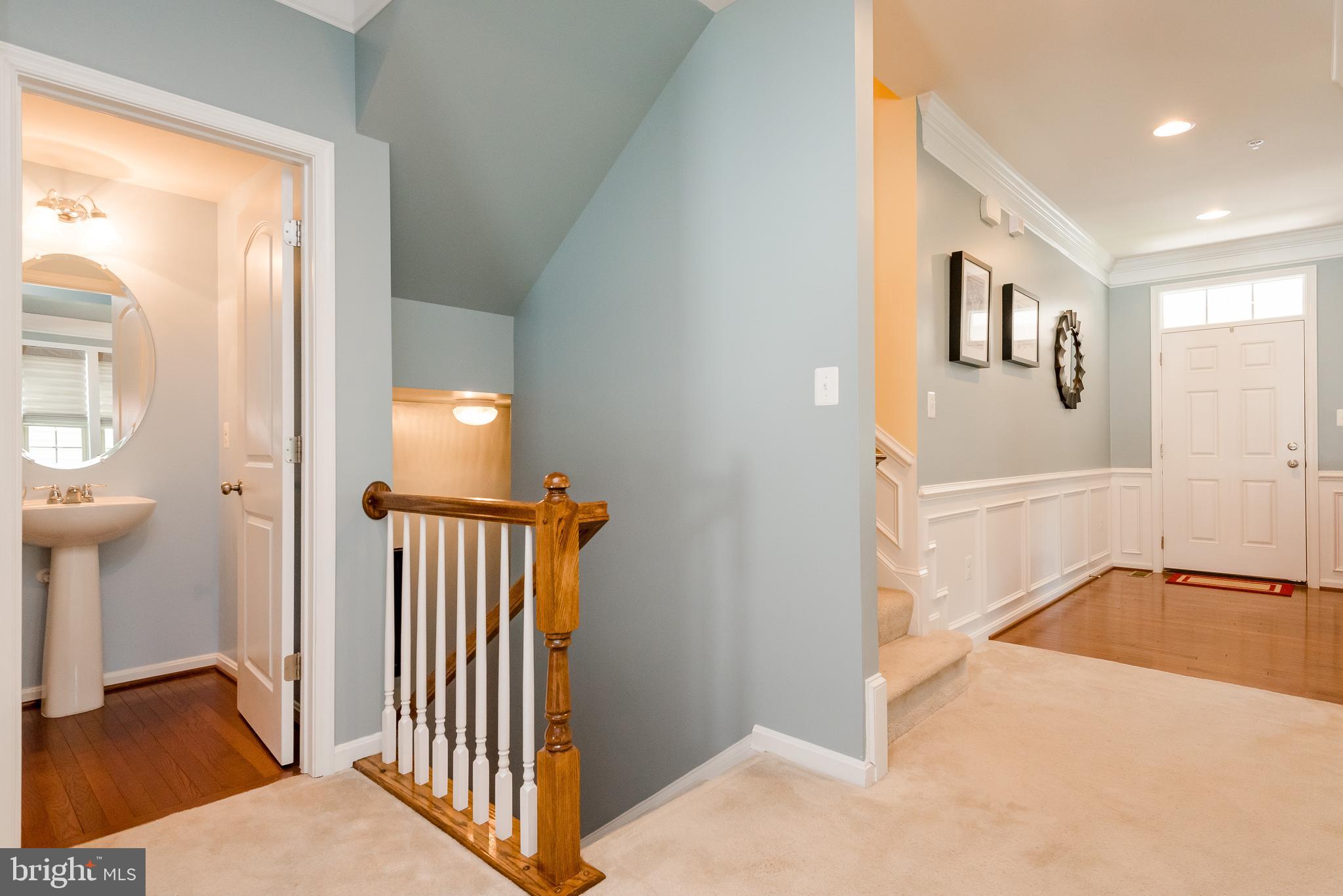 8160 Ridgely Loop Severn, MD 21144 - Photo 8 of 44 Hardwood floors gleam in the Foyer and half-bath