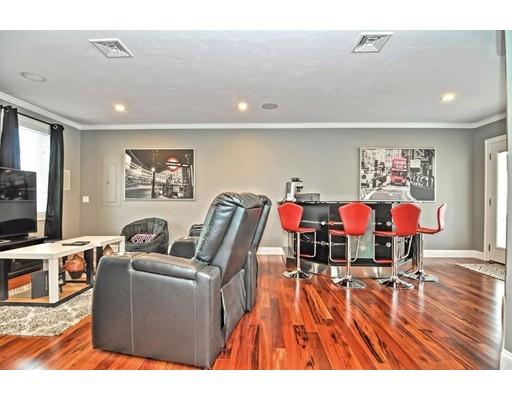 103 Bronson Street Fall River, MA 02721 - Photo 20 of 30 a living room with furniture a flat screen tv and a table