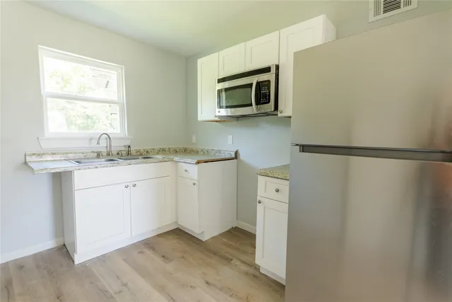 a view of a kitchen with electric appliances