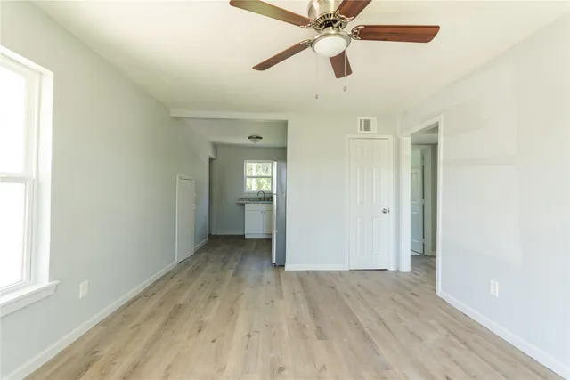 wooden floor in an empty room with a window