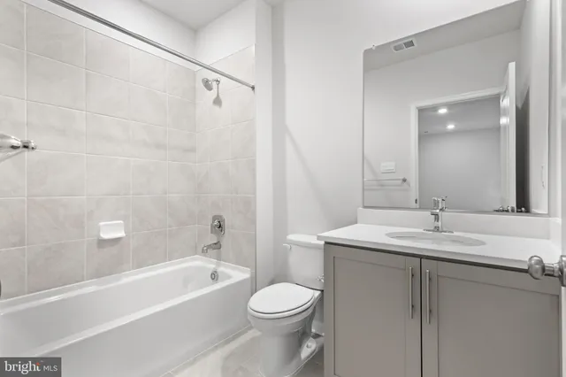 a bathroom with a sink a toilet and a bathtub