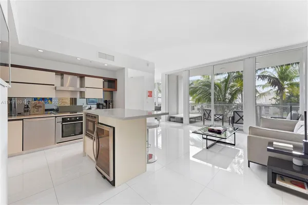 a kitchen with stainless steel appliances a stove a sink and a refrigerator
