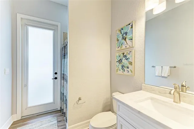 a large room with lots of tables a chandelier and couches