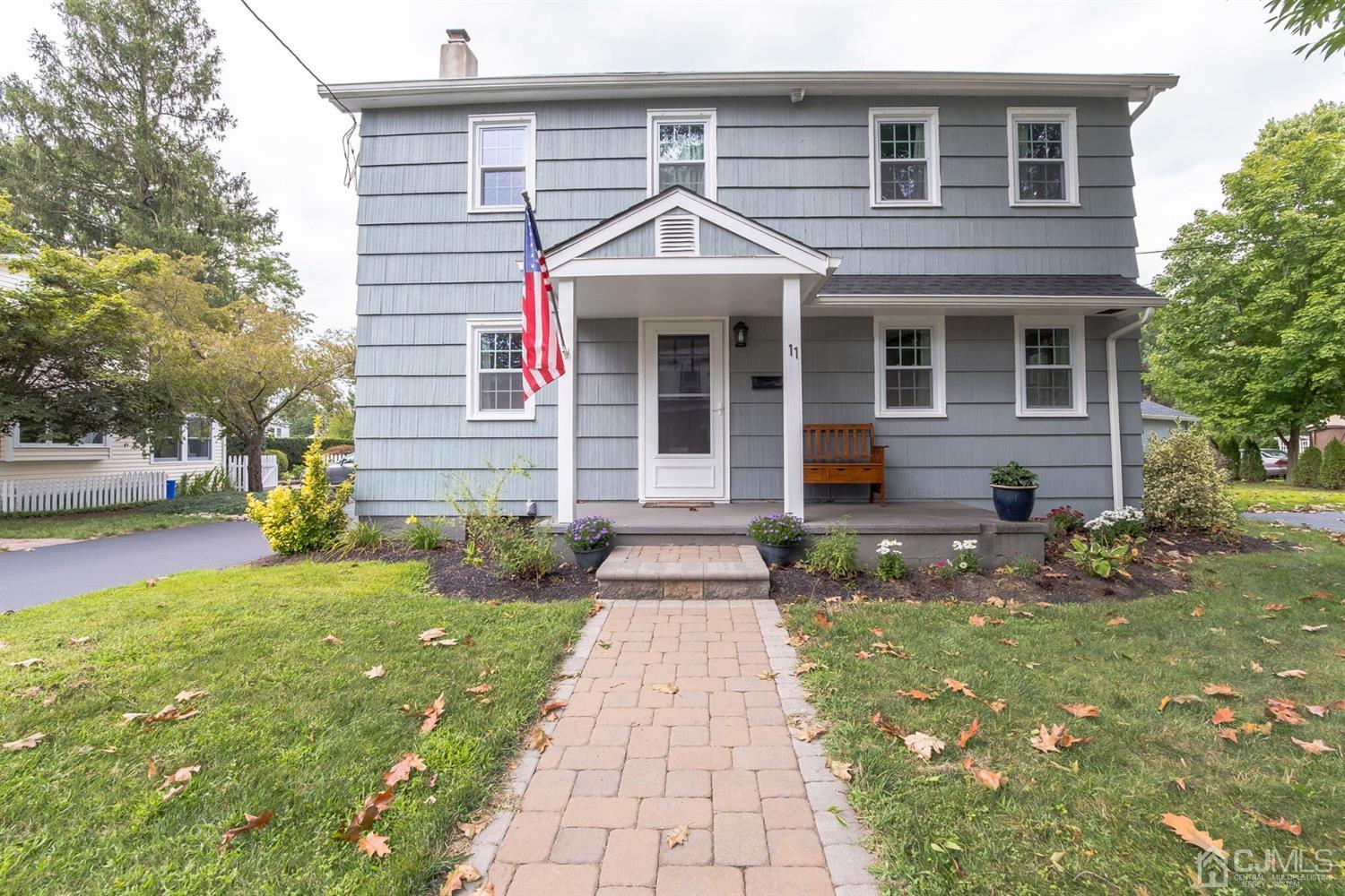 11 Station Road Cranbury, NJ 08512 - Photo 2 of 26 a front view of a house with a yard and potted plants